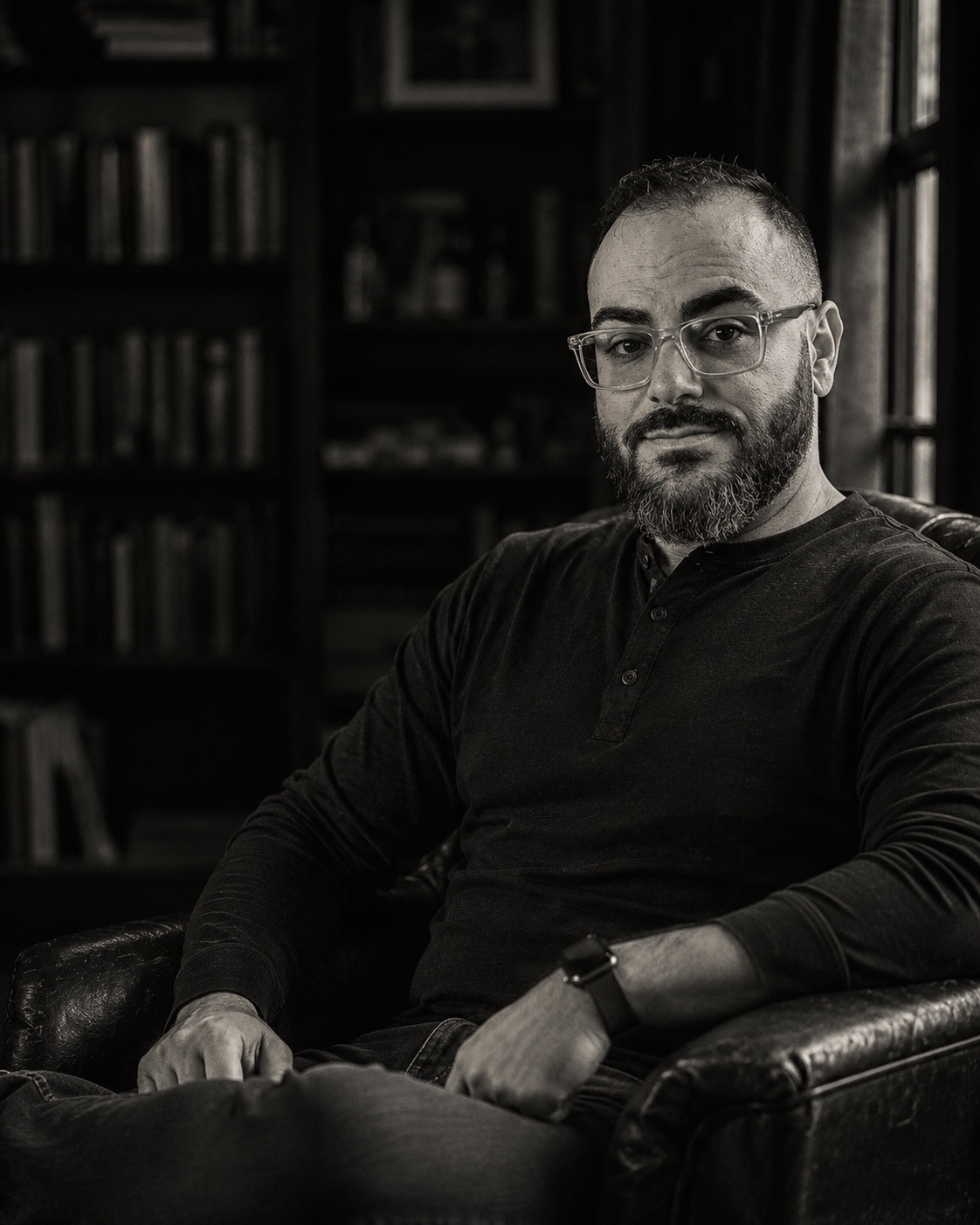 Michael Paul Patrick, founder of the Life After ICU Initiative, seated in a library.